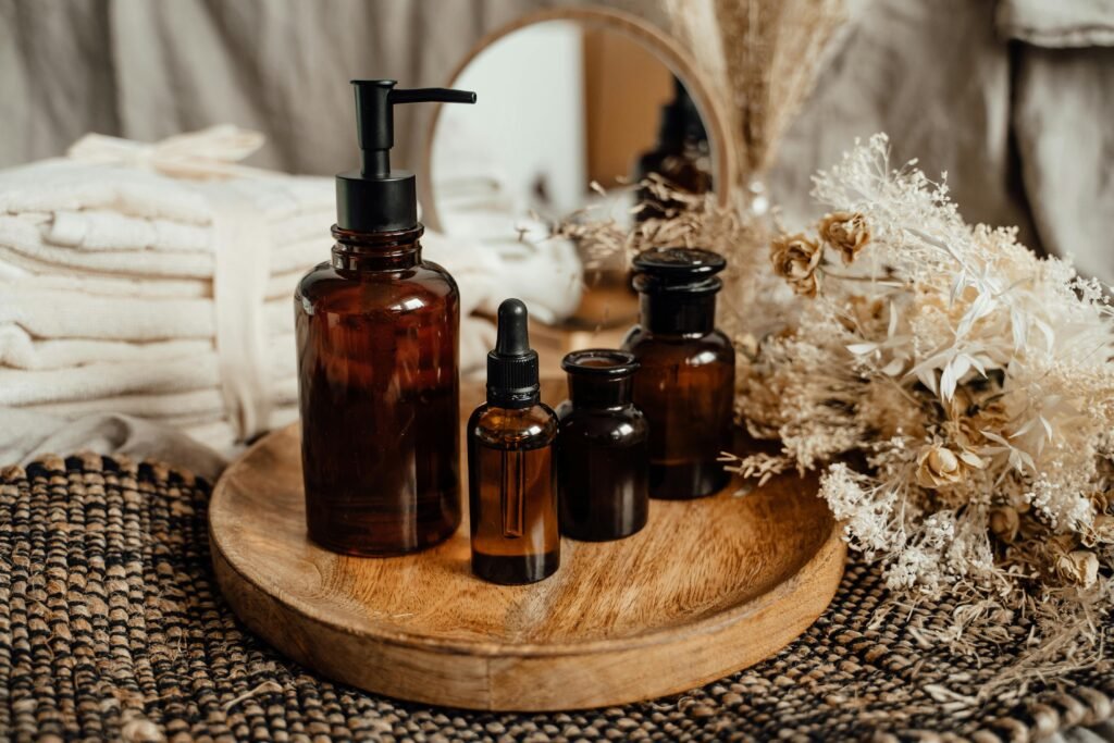 Modern still life with amber glass bottles on a wooden tray, evoking a serene, natural atmosphere.